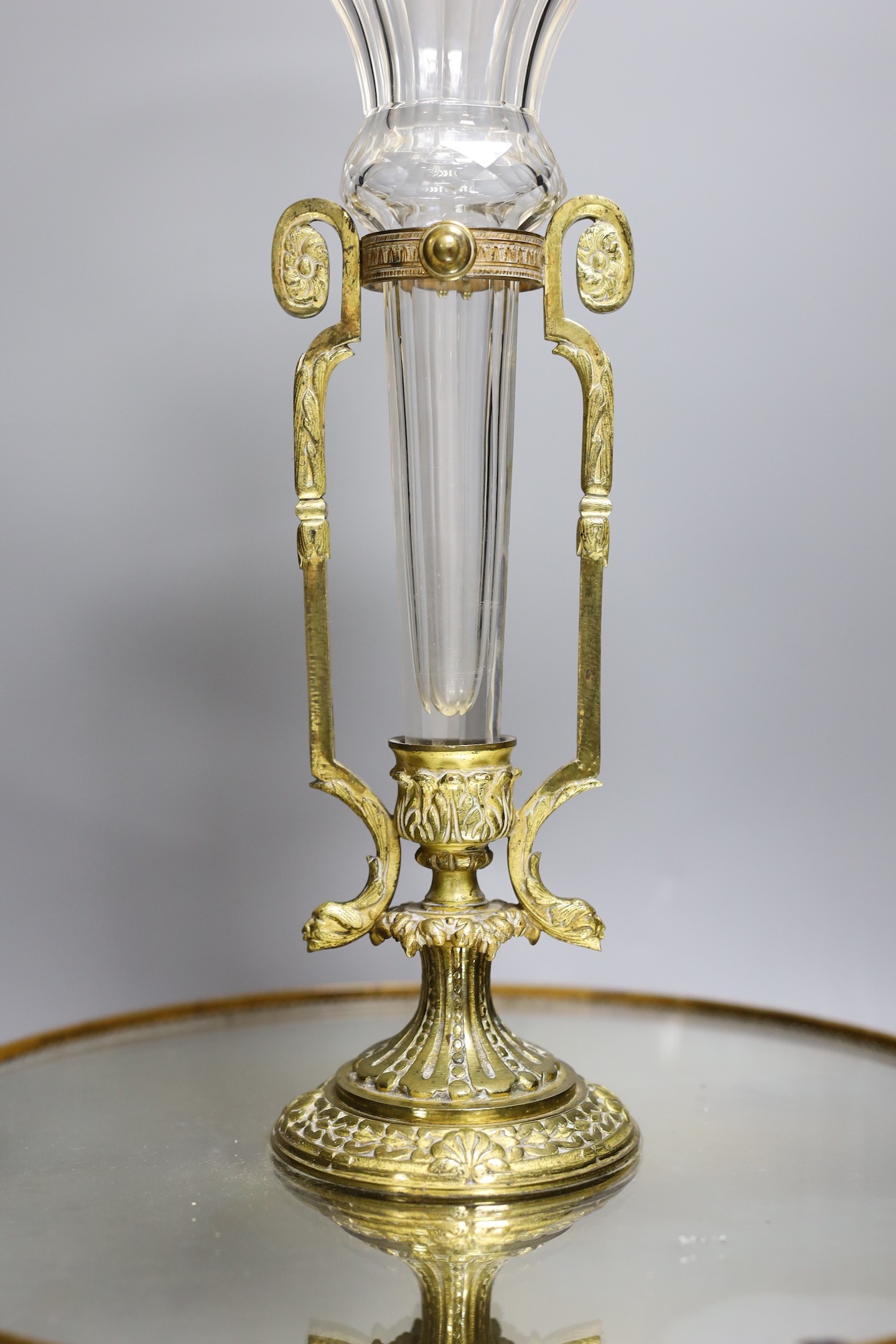 An ormolu and patinated bronze centrepiece with mirrored base and Baccarat style epergne vase, base signed Henry, 44cms high